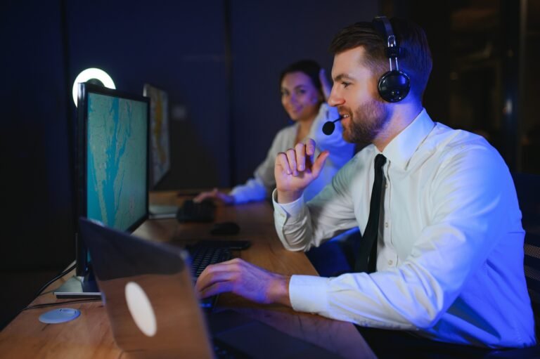 Center of dispatching maintenance. Portrait of cheerful woman and man working via headset microphone